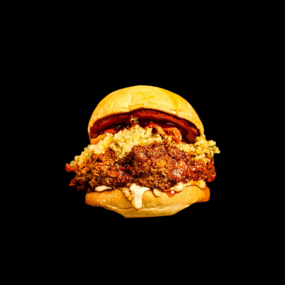 A fried chicken burger on black